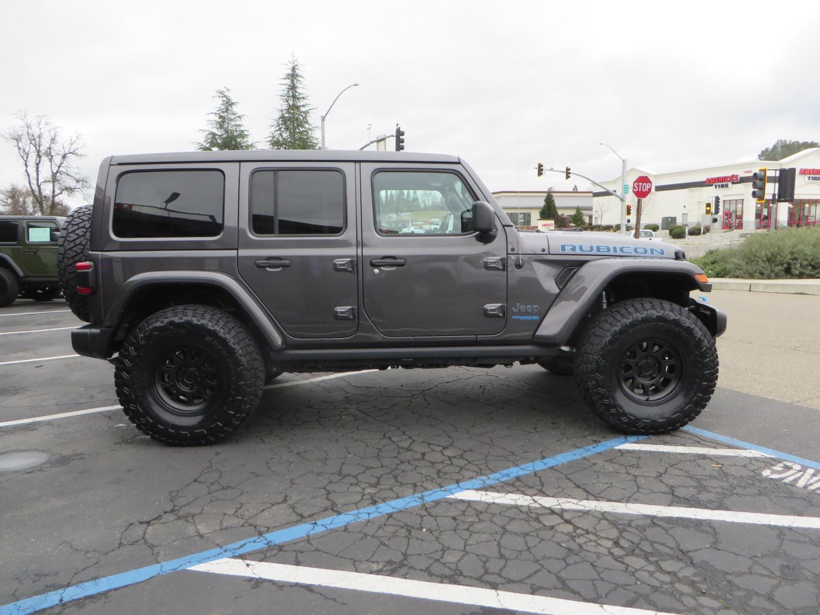 2021 CHARCOAL /BLACK Jeep Wrangler Unlimited Rubicon 4XE 4d SUV 4wd (1C4JJXR60MW) with an 2.0L L4 DOHC 16V TURBO engine, automatic transmission, located at 2630 Grass Valley Highway, Auburn, CA, 95603, (530) 508-5100, 38.937893, -121.095482 - 4XE Rubicon sitting on a Zone offroad suspension system, Fox shocks, 37" Toyo RT trail tires, 17" Method Race wheels, Teraflex Hd tire carrier, and Flat tow ready. - Photo #3
